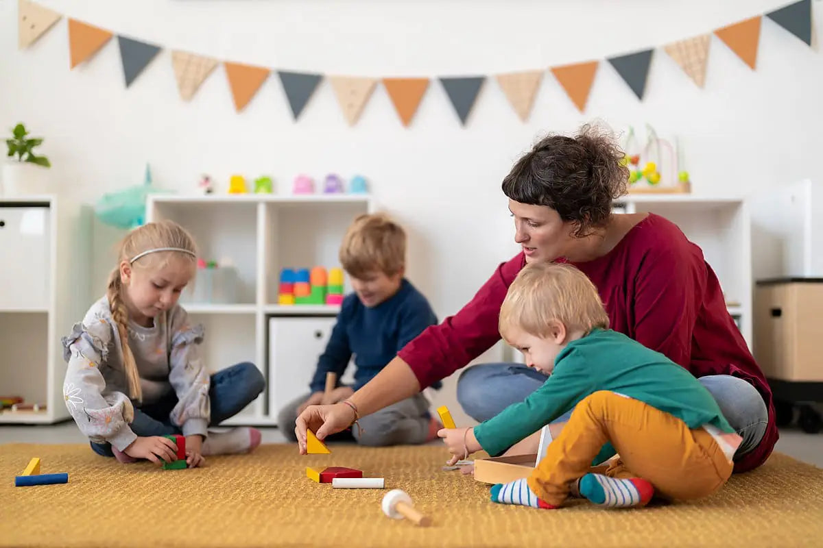 preschool-teacher-playing-with-small-children-using-sensory-tools